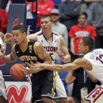 Southern Mississippi's Jonathan Mills (24) can't hold on to the ball against the defense of Arizona's Brandon Ashley (21), Kaleb Tarczewski, rear, and Nick Johnson (13) during the first half of an NCAA college basketball game in Tucson, Ariz., Tuesday, Dec. 4, 2012. (AP Photo/John Miller)