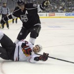 Chicago Blackhawks' Brandon Saad loses his footing as he brings the puck up the ice against Los Angeles Kings center Anze Kopitar (11) during the first period in Game 3 of the NHL hockey Stanley Cup playoffs Western Conference finals, Tuesday, June 4, 2013, in Los Angeles. (AP Photo/Mark J. Terrill)