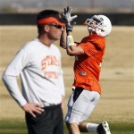 Oklahoma State receiver Charlie Moore pulls in 
a pass as coach Mike Gundy watches practice 
Tuesday, Dec. 27, 2011, in Scottsdale, Ariz. 
Oklahoma State will face Stanford in the Fiesta 
Bowl college football game Jan. 2. (AP 
Photo/Matt York)
