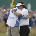 Phil Mickelson of the United States celebrates after his final putt on the 18th green with his caddie Jim Mackay during the final round of the British Open Golf Championship at Muirfield, Scotland, Sunday, July 21, 2013. (AP Photo/Jon Super)