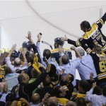 Fans swarm the glass to join the celebration of a Boston Bruins defenseman Johnny Boychuk's goal against the Chicago Blackhawks during the third period in Game 4 of the NHL hockey Stanley Cup Finals, Wednesday, June 19, 2013, in Boston. (AP Photo/Charles Krupa)