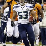 Seattle Seahawks' Malcolm Smith runs for a touchdown after intercepting a Denver Broncos pass during the first half of the NFL Super Bowl XLVIII football game Sunday, Feb. 2, 2014, in East Rutherford, N.J. (AP Photo/Mark Humphrey)