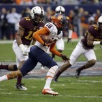Syracuse wide receiver Christopher Clark (18) runs for a first down after catching a pass as Minnesota's Antonio Johnson (11) and Brock Vereen (21) defend during the first quarter of the Texas Bowl NCAA college football game on Friday, Dec. 27, 2013, in Houston. (AP Photo/David J. Phillip)