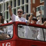 NBA champion Miami Heat president Pat Riley, center, points to fans during a parade honoring the team in Miami, Monday, June 24, 2013. (AP Photo/Alan Diaz)