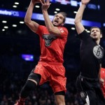 Chicago Bulls' Joakim Noah, left, drives to the basket past Brooklyn Nets' Mirza Teletovic during the first half of the NBA basketball game at the Barclays Center Wednesday, Dec. 25, 2013, in New York. (AP Photo/Seth Wenig)