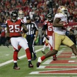 San Francisco 49ers' Frank Gore rushes for a five-yard touchdown during the second half of the NFL football NFC Championship game against the Atlanta Falcons Sunday, Jan. 20, 2013, in Atlanta. Left is Atlanta Falcons' Akeem Dent and William Moore. (AP Photo/Dave Martin)