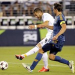 Real Madrid forward Karim Benzema (9) scores on goal as Los Angeles Galaxy defender Todd Dunivant defends during the second half of the International Champions Cup soccer match, Thursday, Aug. 1, 2013, in Glendale, Ariz. Real Madrid won 3-1. (AP Photo/Matt York)
