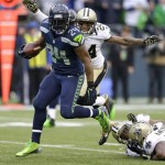 Seattle Seahawks running back Marshawn Lynch (24) runs for a 15-yard touchdown in front of New Orleans Saints cornerback Corey White (24) during the second quarter of an NFC divisional playoff NFL football game in Seattle, Saturday, Jan. 11, 2014. (AP Photo/Ted S. Warren)