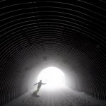A snowboarder goes through a tunnel near the alpine skiing training slopes at the Sochi 2014 Winter Olympics, Monday, Feb. 17, 2014, in Krasnaya Polyana, Russia. (AP Photo/Christophe Ena)