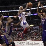 Los Angeles Clippers' Mo Williams, center, drives to the basket against Phoenix Suns' Jared Dudley, left, Michael Redd, second from left, and Channing Frye during the second half of an NBA basketball game in Los Angeles, Thursday, March 15, 2012. The Suns won 91-87. (AP Photo/Jae C. Hong)