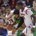 Oregon forward Arsalan Kazemi battles to drive through Louisville guard Wayne Blackshear (20) and center Gorgui Dieng (10) during the second half of a regional semifinal in the NCAA college basketball tournament, Friday, March 29, 2013, in Indianapolis. Louisville won 77-69. (AP Photo/Michael Conroy)
