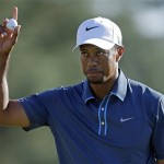 Tiger Woods holds up his ball after putting out on the 18th hole during the third round of the Masters golf tournament Saturday, April 13, 2013, in Augusta, Ga. (AP Photo/David Goldman)
