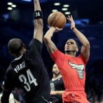 Chicago Bulls' D.J. Augustin, right, is fouled by Brooklyn Nets' Paul Pierce during the first half of the NBA basketball game at the Barclays Center Wednesday, Dec. 25, 2013, in New York. (AP Photo/Seth Wenig)
