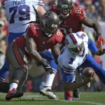 Buffalo Bills quarterback EJ Manuel (3) eludes Tampa Bay Buccaneers defensive end Adrian Clayborn (94) on a run during the first quarter of an NFL football game on Sunday, Dec. 8, 2013, in Tampa, Fla. (AP Photo/Phelan M. Ebenhack)