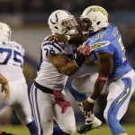 Indianapolis Colts fullback Stanley Havili, third from right, has his hands full as San Diego Chargers outside linebacker Larry English (51) rushes during the first half of an NFL football game Monday, Oct. 14, 2013, in San Diego. (AP Photo/Lenny Ignelzi)