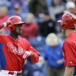 Philadelphia Phillies' Domonic Brown, left, and Erik Kratz celebrate after Brown's home run during the fourth inning of a spring training exhibition baseball game against the Toronto Blue Jays, Sunday, March 3, 2013, in Clearwater, Fla. Philadelphia won 13-5. (AP Photo/Matt Slocum)