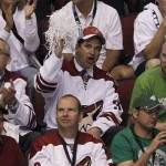 Chicago businessman Matthew Hulsizer, middle, 
who is trying to buy the Phoenix Coyotes, 
cheers on the team during the second period 
in Game 4 of a first-round NHL hockey Stanley 
Cup playoffs series against the Detroit Red 
Wings Wednesday, April 20, 2011, in Glendale, 
Ariz. The Red Wings defeated the Coyotes 6-3 
and earned a 4-0 sweep in the series. (AP 
Photo/Ross D. Franklin)