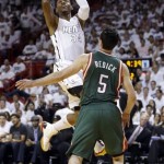 Miami Heat's Ray Allen (34) shoots over Milwaukee Bucks' J.J. Redick (5) during the first half of Game 1 of their first-round NBA basketball playoff series in Miami, Sunday April 21, 2013. The Heat won 110-87. (AP Photo/Alan Diaz)