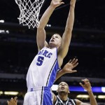 Duke forward Mason Plumlee (5) goes up with a shot past Michigan State forward Adreian Payne (5) during the second half of a regional semifinal in the NCAA college basketball tournament, Friday, March 29, 2013, in Indianapolis. (AP Photo/Michael Conroy)