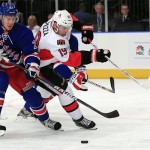 New York Rangers' Ryan McDonagh (27) and Ottawa Senators' Jason Spezza (19) fight for control of the puck during the first period of Game 1 of a first-round NHL hockey playoff series, Thursday, April 12, 2012, in New York. (AP Photo/Frank Franklin II)