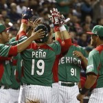 Mexico's Ramiro Pena (19) celebrates a run scored against the United States with teammates, including Alfredo Aceves (91), Sebastian Valle (9), and Walter Ibarra, far left, in the first inning during a World Baseball Classic baseball game on Friday, March 8, 2013, in Phoenix. (AP Photo/Ross D. Franklin)