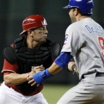 Arizona Diamondbacks catcher Wil Nieves, left, tags out Chicago Cubs' David DeJesus, who was trying to score in the seventh inning of a baseball game Sunday, Sept. 30, 2012, in Phoenix. (AP Photo/Rick Scuteri)