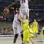 Louisville forward Montrezl Harrell (24) and Michigan guard Spike Albrecht (2) work for a loose ball during the first half of the NCAA Final Four tournament college basketball championship game Monday, April 8, 2013, in Atlanta. (AP Photo/David J. Phillip)