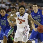 Florida's Mike Rosario (3) is pursued by Florida Gulf Coast's Sherwood Brown (25) and Chase Fieler (20) during the first half of a regional semifinal game in the NCAA college basketball tournament, Friday, March 29, 2013, in Arlington, Texas. (AP Photo/David J. Phillip)