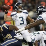 Seattle Seahawks quarterback Russell Wilson (3) works against the St. Louis Rams during the first half of an NFL football game, Monday, Oct. 28, 2013, in St. Louis. (AP Photo/Michael Conroy)