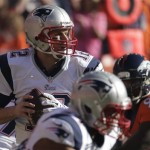 
New England Patriots quarterback Tom Brady (12) looks for an opening to pass during the first half of the AFC Championship NFL playoff football game against the Denver Broncos in Denver, Sunday, Jan. 19, 2014. (AP Photo/Charlie Riede