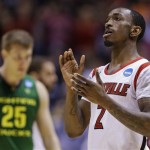 Louisville guard Russ Smith (2) reacts after his team's 77-69 win over Oregon in a regional semifinal against Oregon in the NCAA college basketball tournament, Friday, March 29, 2013, in Indianapolis. At left is Oregon's E.J. Singler (25). (AP Photo/Michael Conroy)

