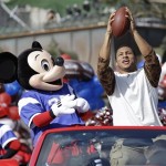 The 2014 Super Bowl MVP Malcolm Smith, of the Seattle Seahawks, catches a football thrown to him as he rides in a parade at Walt Disney World with Mickey Mouse, Monday, Feb. 3, 2014, in Lake Buena Vista, Fla. The Seahawks defeated the Denver Broncos 43-8 in Sunday's Super Bowl XLVIII NFL football game in East Rutherford, N.J. (AP Photo/John Raoux)