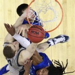 Georgetown's Nate Lubick, left, tries to shoot past Florida Gulf Coast's Chase Fieler, top, and Sherwood Brown during the first half of a second-round game of the NCAA college basketball tournament on Friday, March 22, 2013, in Philadelphia. (AP Photo/Matt Rourke)