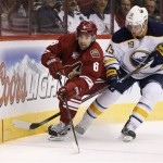  Phoenix Coyotes' David Schlemko (6) and Buffalo Sabres' Cody Hodgson (19) skate after the puck during the first period of an NHL hockey game on Thursday, Jan. 30, 2014, in Glendale, Ariz. (AP Photo)