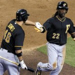 Pittsburgh Pirates' Andrew McCutchen (22) gets a high-five from teammate Garrett Jones (46) after scoring a run against the Arizona Diamondbacks during the third inning of a baseball game Tuesday, April 17, 2012, in Phoenix. (AP Photo/Ross D. Franklin)