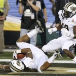 Central Florida's Rannell Hall, left, leaps into the end zone for a touchdown against Baylor as teammate Josh Reese (19) arrives to celebrate during the first half of the Fiesta Bowl NCAA college football game Wednesday, Jan. 1, 2014, in Glendale, Ariz. (AP Photo/Ross D. Franklin)
