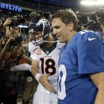 Denver Broncos quarterback Peyton Manning (18) shakes hands with his brother New York Giants' quarterback Eli Manning (10) after an NFL football game Sunday, Sept. 15, 2013, in East Rutherford, N.J. The Broncos won the game 41-23. (AP Photo/Frank Franklin II)
