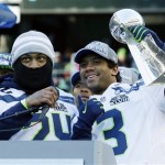 Seattle Seahawks quarterback Russell Wilson, right, lifts the Vince Lombardi Trophy next to Seahawks running back Marshawn Lynch, left, during a rally on Wednesday, Feb. 5, 2014, in Seattle. The Seahawks defeated the Denver Broncos on Sunday in NFL football's Super Bowl XLVIII game in East Rutherford, N.J. (AP Photo/Ted S. Warren)