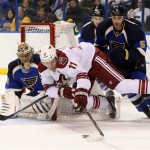 Phoenix Coyotes center Martin Hanzal (11) tries to wrap around the net as he is defended by St. Louis Blues goaltender Jaroslav Halak, left, and defenseman Barret Jackman during the second period of an NHL hockey game Tuesday, Jan. 14, 2014, in St. Louis. The Blues won 2-1. (AP Photo/St. Louis Post-Dispatch, Chris Lee) 