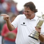 Phil Mickelson of the United States gestures as he holds the Claret Jug trophy after winning the British Open Golf Championship at Muirfield, Scotland, Sunday, July 21, 2013. (AP Photo/Matt Dunham)