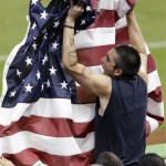 A fan waves the United States flag during the second inning of a second-round World Baseball Classic game against Puerto Rico, Tuesday, March 12, 2013, in Miami. (AP Photo/Wilfredo Lee)