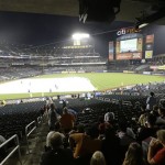 Fans take shelter from the weather during a rain delay of a baseball game between the New York Mets and the Arizona Diamondbacks Tuesday, July 2, 2013, in New York. (AP Photo/Frank Franklin II)