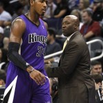 Sacramento Kings head coach Keith Smart, right, talks with Jason Thompson (34) during the first half of an NBA preseason basketball game against the Phoenix Suns, Monday, Oct. 22, 2012, in Phoenix. (AP Photo/Ross D. Franklin)
