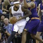 Sacramento Kings center DeMarcus Cousins, left, looks to pass against Phoenix Suns center Channing Frye during the first quarter of an NBA basketball game in Sacramento, Calif., Tuesday, Nov. 19, 2013.(AP Photo/Rich Pedroncelli)