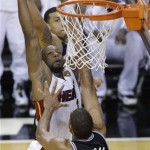 The Miami Heat's Dwyane Wade (3) shoots over San Antonio Spurs' Tim Duncan (21) during the second half in Game 7 of the NBA basketball championships, Thursday, June 20, 2013, in Miami. (AP Photo/Wilfredo Lee)
