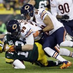 Green Bay Packers quarterback Aaron Rodgers is sacked by Chicago Bears' Shea McClellin (99) and Isaiah Frey (31) during the first half of an NFL football game Monday, Nov. 4, 2013, in Green Bay, Wis. (AP Photo/Morry Gash)