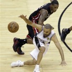 San Antonio Spurs' Tony Parker (9) loses the ball as Miami Heat's Mario Chalmers defends during the second half at Game 4 of the NBA Finals basketball series, Thursday, June 13, 2013, in San Antonio. (AP Photo/David J. Phillip)