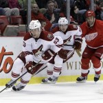 Phoenix Coyotes defenseman Derek Morris (53) controls the puck in front of left wing Ray Whitney (13) and Detroit Red Wings right wing Todd Bertuzzi (44) during the second period of an NHL hockey game in Detroit, Thursday, Dec. 8, 2011. Detroit won 5-2. (AP Photo/Carlos Osorio)