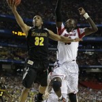 Wichita State's Tekele Cotton (32) heads to he hoop as Louisville's Gorgui Dieng (10) during the first half of the NCAA Final Four tournament college basketball semifinal game Saturday, April 6, 2013, in Atlanta. (AP Photo/David J. Phillip)
