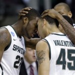  Michigan State forward Branden Dawson (22), and Denzel Valentine (45) celebrate with Keith Appling, obscured at right, during a timeout in the first half of a second-round NCAA college basketball tournament game in Auburn Hills, Mich., Thursday March 21, 2013. (AP Photo/Paul Sancya)
